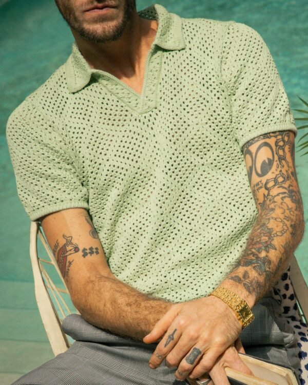 Man with tattoos sitting poolside in a Dandy Del Mar Antibes Crochet Shirt - Pistachio.