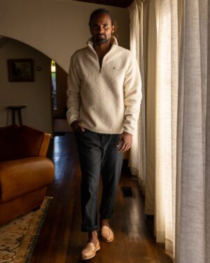 man waling by living room windows in Cusco Sherpa Pullover