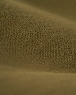 Close-up view of a textured brown fabric, with visible weave and fibers, reminiscent of the fine detailing seen in The Brisa Linen Blazer - Berdea by Dandy Del Mar.