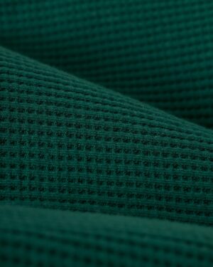 Close-up of The Cannes Waffle Knit Robe - Albero by Dandy Del Mar, highlighting its green waffle-textured pattern and texture.