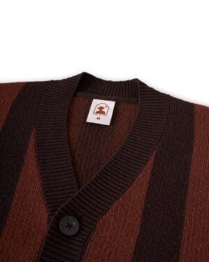 A close-up of the luxury Florence Knit Cardigan - Garam by Dandy Del Mar, highlighting its elegant brown and black jacquard knit stripes, adorned with a button and featuring a label with the logo and size 