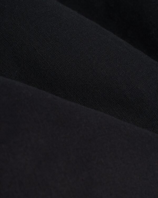 A close-up of the Dandy Del Mar Brisa Linen Trouser - Onyx.