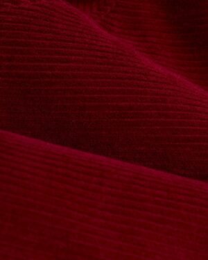 Close-up view of Italian corduroy fabric, showcased in the Dandy Del Mar Corsica Corduroy Jacket - Sangria, highlighting its rich, textured, ribbed surface.