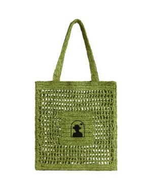 The Amabile Raffia Bag - Verde by Dandy Del Mar is a green, handwoven tote bag with a rectangular shape and square cutouts, crafted from raffia-effect yarn and featuring a small black silhouette of a woman's profile in the center.