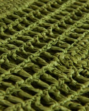 Close-up of The Amabile Raffia Bag - Verde by Dandy Del Mar, showcasing its green braided texture and interwoven pattern, evoking a coastal mood.