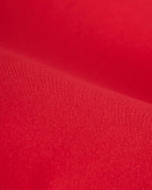 Close-up view of a red fabric, showcasing its texture and folds, reminiscent of the luxurious material found in The Hierro Top - Pico by Dandy Del Mar, perfect for Summer Leisure Chic.